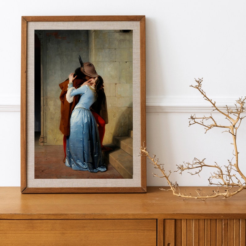 May include: A painting of a couple kissing in a hallway. The man is wearing a brown coat and a hat, and the woman is wearing a blue dress. The painting is set against a backdrop of stone walls and a staircase.