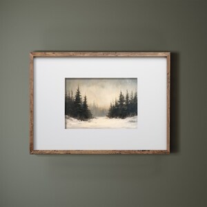 May include: A framed painting of a snowy forest scene with tall evergreen trees in the background. The trees are silhouetted against a hazy, light blue sky. The foreground is covered in snow.
