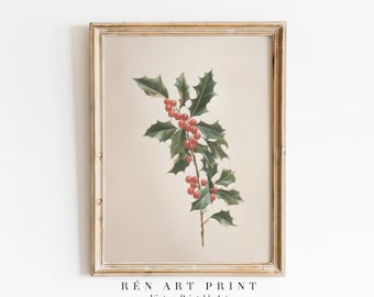 May include: A framed vintage art print featuring a botanical illustration of a holly branch with green leaves and red berries. The print has a beige background and is framed in a gold-toned wooden frame. The text "RÉN ART PRINT Vintage Printable Art" is at the bottom.