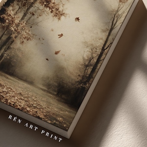 May include: A rectangular canvas art print featuring a sepia-toned forest scene with falling autumn leaves, bare trees, and a ground covered in foliage. The text R&Eacute;N ART PRINT is printed in white capital letters at the bottom left corner of the canvas.