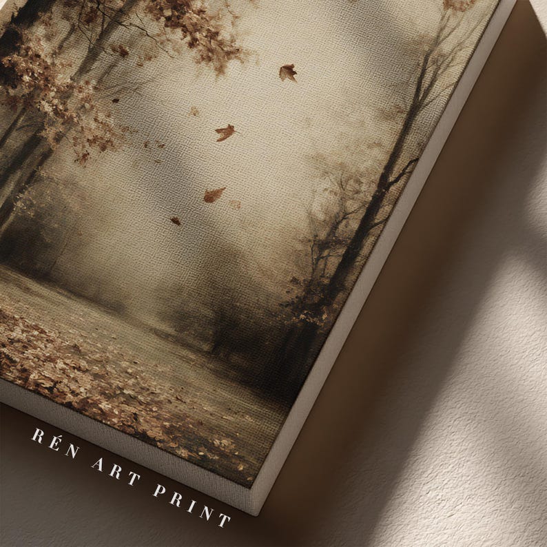 May include: A rectangular canvas art print featuring a sepia-toned forest scene with falling autumn leaves, bare trees, and a ground covered in foliage. The text R&Eacute;N ART PRINT is printed in white capital letters at the bottom left corner of the canvas.