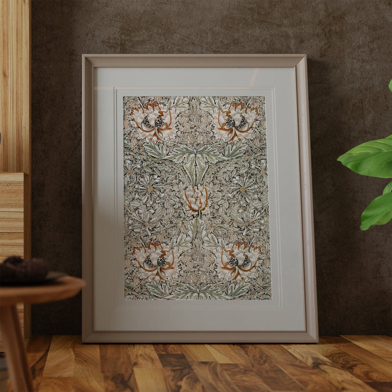 May include: A framed print of a vintage floral pattern in shades of green, brown, and white. The pattern features stylized flowers and leaves.