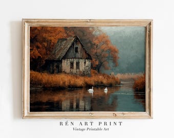 May include: A framed vintage art print depicts a rustic cabin on a riverbank, surrounded by autumn foliage. Two white swans float on the water. The print has a warm color palette of browns, oranges, and blues. The text "RÉ N ART PRINT Vintage Printable Art" is at the bottom.