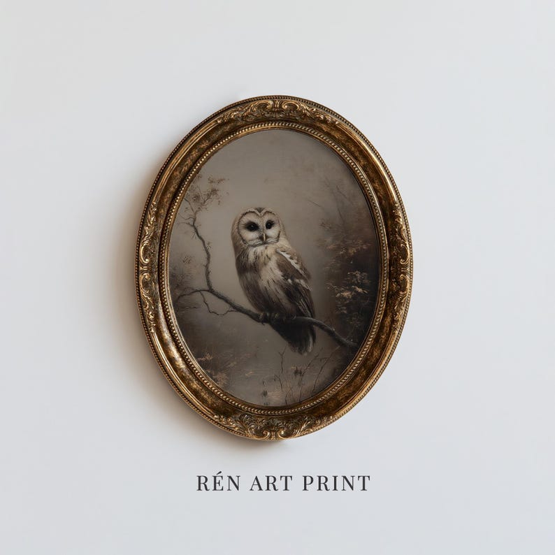 May include: An oval-shaped, ornate gold-toned frame containing an art print of a barn owl perched on a bare tree branch. The artwork features muted grey and brown tones. Below the frame, the text R&Eacute;N ART PRINT is displayed in black lettering.