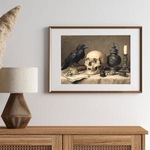 May include: A framed print featuring a still life with a skull, raven, and antique objects. The artwork has a vintage aesthetic, with a skull, a black raven, a candle, and a lantern. The color palette is muted, with shades of brown, beige, and black.