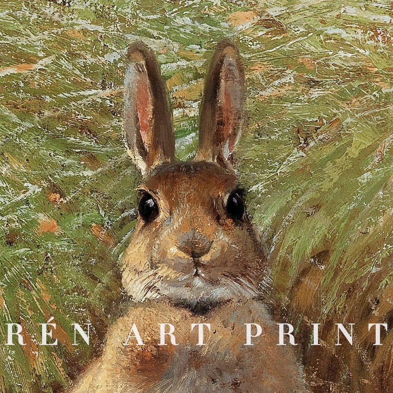 May include: A close-up of a brown rabbit with large ears, looking directly at the viewer. The rabbit is in a field of green grass.