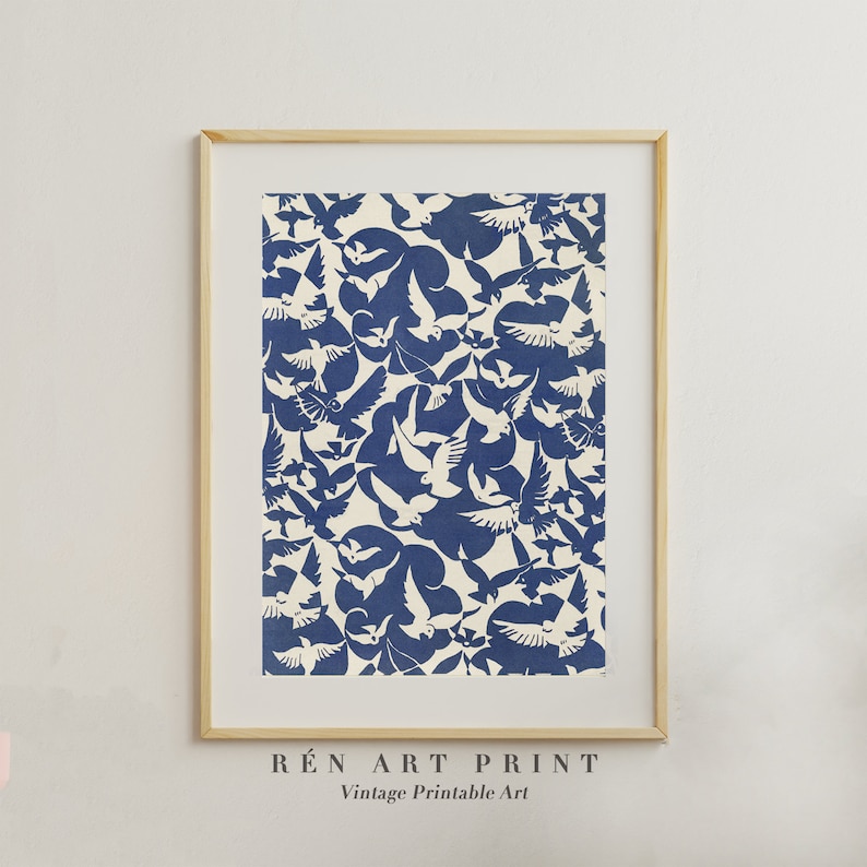 K&ouml;nnte beinhalten: Ein druckbarer Kunstdruck mit einem Vintage-Design aus wei&szlig;en V&ouml;geln auf blauem Hintergrund. Der Druck ist in einem hellen Holzrahmen gerahmt und tr&auml;gt unten den Text "R&Eacute;N ART PRINT Vintage Printable Art".