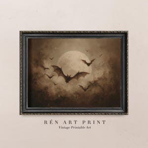 May include: A framed vintage art print in sepia tones. The artwork shows bats silhouetted against a full moon and a cloudy sky. The print is in a black frame, with the text "RÉN ART PRINT Vintage Printable Art" at the bottom.