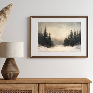 May include: A framed painting of a snowy forest scene with dark green pine trees in the foreground and a light gray sky in the background.
