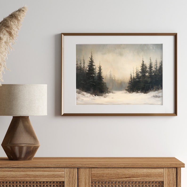 May include: A framed painting of a snowy forest scene with dark green pine trees in the foreground and a light gray sky in the background.