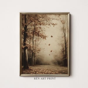 May include: A framed art print featuring a sepia-toned forest scene with tall trees, fallen leaves covering the ground, and several leaves drifting through the air. The text RÉN ART PRINT is visible at the bottom center of the frame.