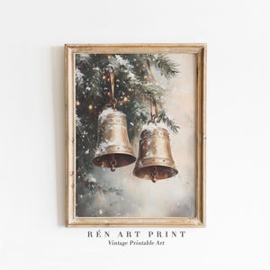 May include: A vintage Christmas print depicting two gold bells hanging from a snow-covered evergreen branch. The bells are decorated with intricate details and have a warm, rustic feel.