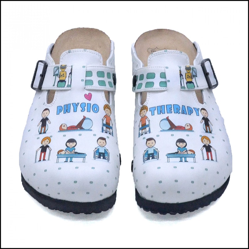 May include: White clogs with a black strap and a green and white patterned strap. The clogs have a white background with a pattern of small blue dots. The clogs have a graphic of a heart and the words "PHYSIO THERAPY" with illustrations of people doing physical therapy exercises.