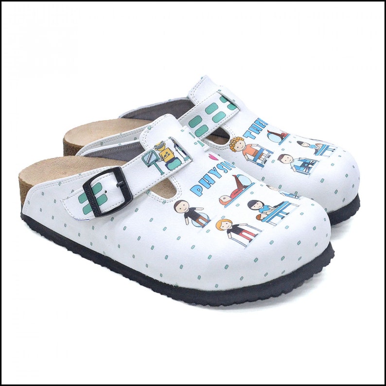 May include: White clogs with a black buckle and a green and blue print of people doing physical therapy exercises. The print includes the text "I love Physio".