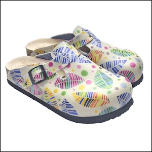 May include: A pair of cream-colored clogs with a colorful leaf pattern. The leaves are in shades of blue, green, yellow, pink, and purple. The clogs have a black sole and a buckle closure.