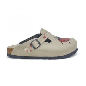 May include: Beige leather clog with a red ladybug design and a black buckle. The clog has a cork sole.