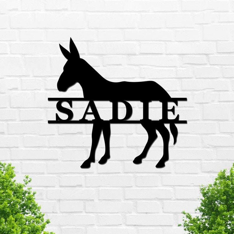 May include: Black metal silhouette of a donkey with the name "SADIE" split in half above and below the animal.