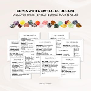 May include: A collection of various polished gemstones in colors including yellow, green, red, and purple, arranged above several white square cards. The text reads COMES WITH A CRYSTAL GUIDE CARD DISCOVER THE INTENTION BEHIND YOUR JEWELRY and CRYSTALS CHOKERS.
