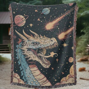 May include: A woven tapestry featuring a colorful dragon with a blue and yellow body, a black background, and a starry sky with shooting stars.