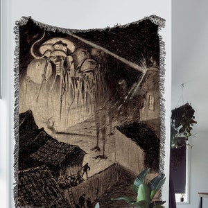 May include: A black and white woven tapestry depicting a scene from the science fiction novel "The War of the Worlds" by H.G. Wells. The image shows a group of Martian fighting machines attacking a town.