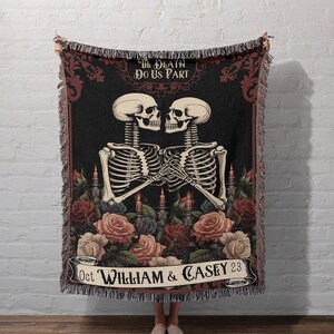 May include: A black woven throw blanket with a gothic wedding theme. Two skeletons are holding hands and are surrounded by roses and candles. The text reads "Til Death Do Us Part" and "Oct William & Casey 23".