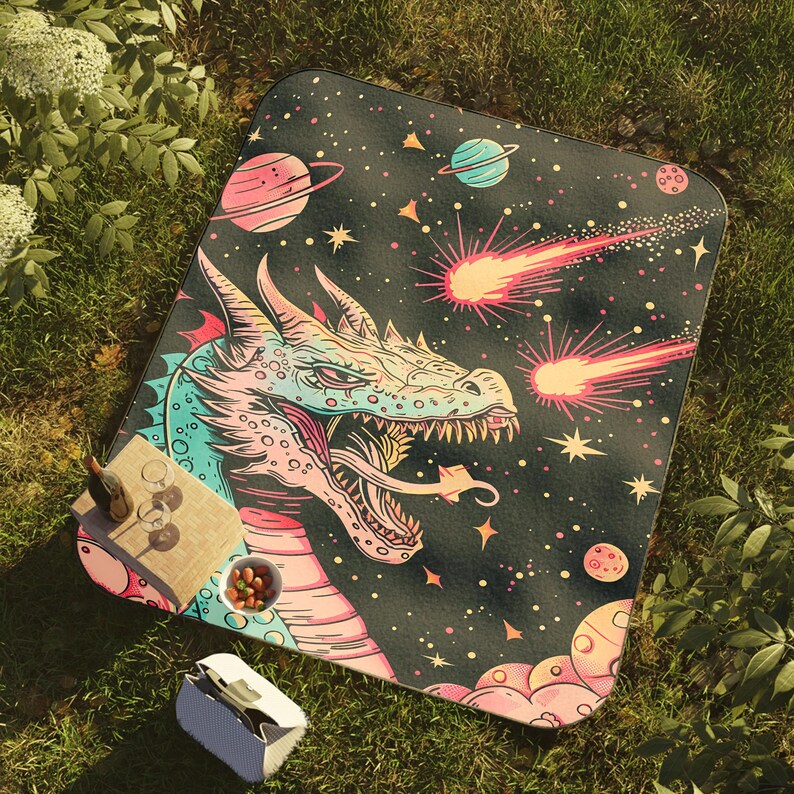 May include: A colorful dragon with pink, blue, and green scales is featured on a black background with stars, planets, and shooting stars. The dragon is facing the viewer with its mouth open and teeth showing.