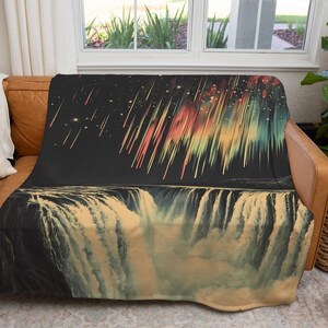 May include: A soft, plush throw blanket featuring a colorful abstract design of a waterfall with a starry night sky and shooting stars above.
