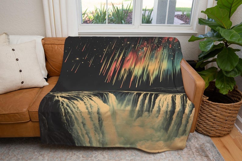 May include: A soft, plush throw blanket featuring a colorful abstract design of a waterfall with a starry night sky and shooting stars above.
