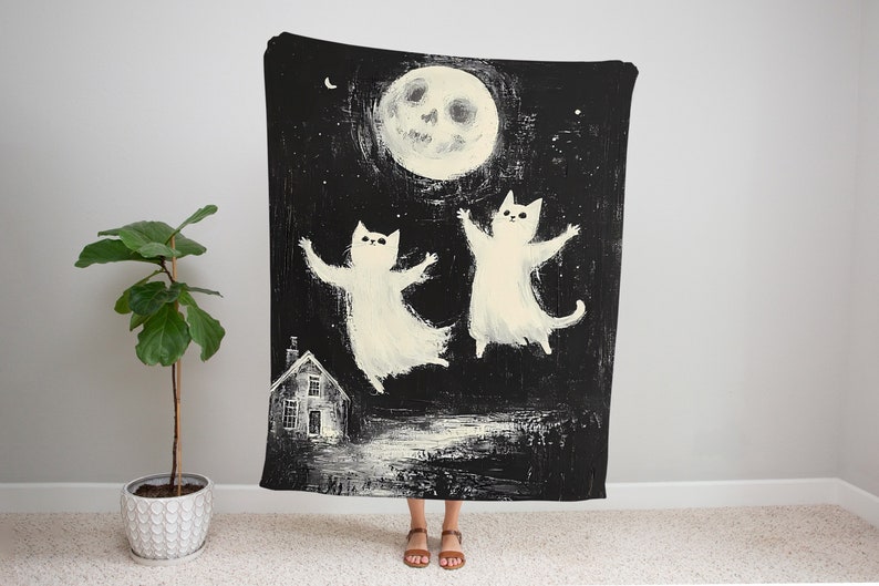 May include: Black and white illustration of two white cats flying in the air with a smiling moon in the background. The cats are silhouetted against a dark night sky with stars. A small house is visible in the foreground.