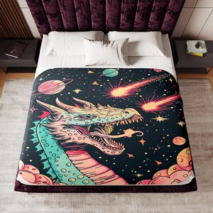 May include: A colorful illustration of a dragon's head with a pink, green, and blue color scheme. The dragon is set against a dark blue background with stars, planets, and comets.
