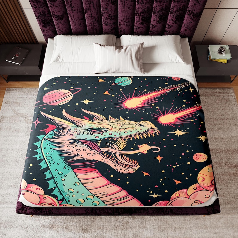 May include: A colorful illustration of a dragon's head with a pink, green, and blue color scheme. The dragon is set against a dark blue background with stars, planets, and comets.