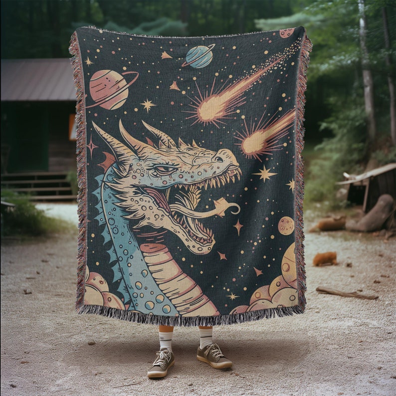 May include: A woven tapestry featuring a colorful dragon with a blue and yellow body, a black background, and a starry sky with shooting stars.