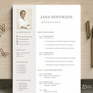 May include: A professional resume template featuring "Jana Hoffmann" in a serif font. The document includes sections for contact details, skills, and work experience. A photo of a woman in a white blazer is in the upper left. Gold paper clips and a pen are on the wooden surface.