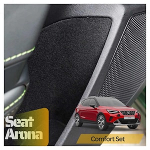 May include: A red Seat Arona car with the text "Comfort Set" on a black and gray car interior with black carpet.