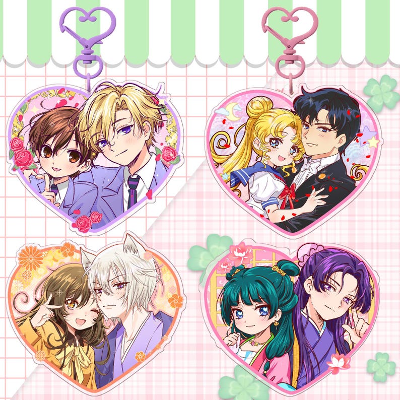 May include: Four heart-shaped anime character keychains. Each keychain features a different couple, with vibrant colors and detailed artwork. The keychains have a heart-shaped clasp at the top, and are perfect for fans of anime and manga.