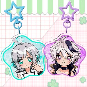 May include: Two anime-style keychains. One features a light blue star-shaped charm and a character with white hair and teal eyes. The other has a purple star charm and a character with white and black hair and purple eyes.