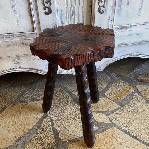 French milking stool , tripod wooden rustic stool in solid dark coloured wood