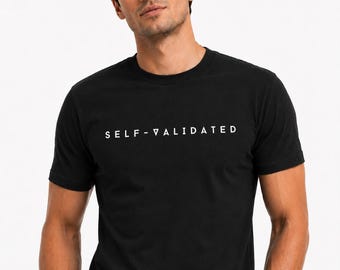 May include: A black short-sleeved crew neck t-shirt featuring the text SELF-VALIDATED printed in white capital letters across the chest. The garment is made of a solid black fabric with a standard fit and a simple, clean design for everyday wear.
