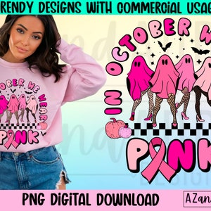 May include: Pink sweatshirt with the text "October We Wear Pink" and a graphic of ghosts wearing fishnet stockings and high heels. The design includes pumpkins, bats, and a pink ribbon. The image also includes the text "PNG DIGITAL DOWNLOAD".
