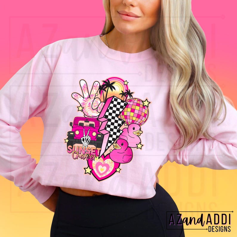 May include: Pink long-sleeved sweatshirt with a graphic design featuring a pink car, a lightning bolt, a peace sign, palm trees, a pink heart, and the text "Sunset Chapter".