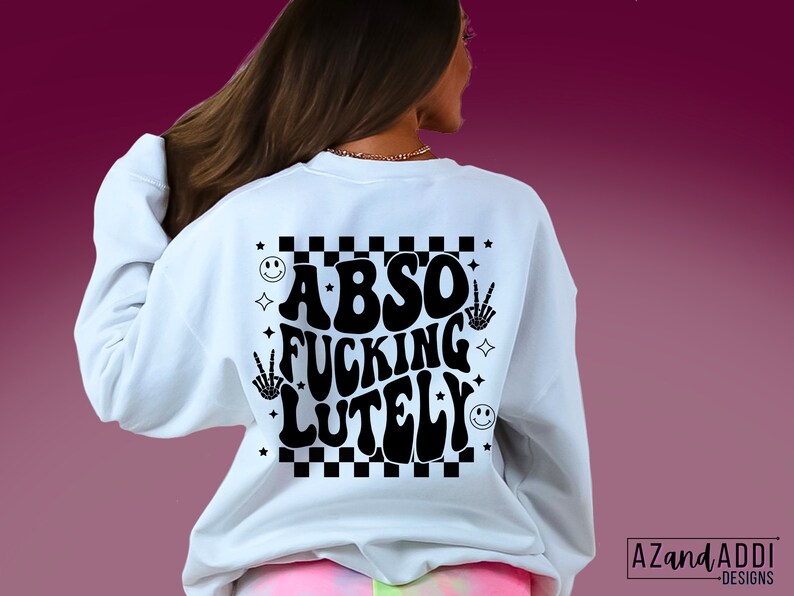 May include: White sweatshirt with a black graphic print that says "Abso Fucking Lutely" in a retro font. The graphic also includes a checkered pattern, smiley faces, and peace signs.