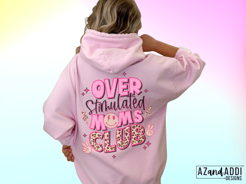 May include: Pink hoodie with the text "Over Stimulated Moms Club" in pink and black lettering with a leopard print design and peace sign graphics.
