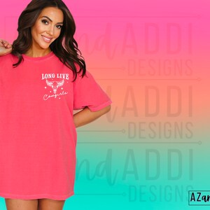 May include: An oversized pink t-shirt with a white graphic design that says "Long Live Cowgirls" with a stylised cow skull and stars.
