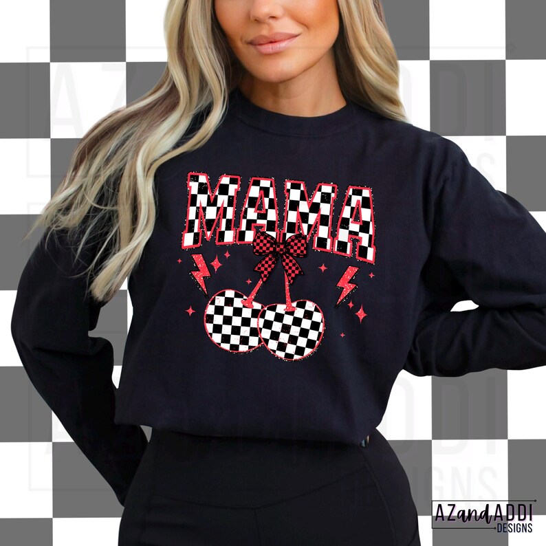 May include: Black sweatshirt with a red "MAMA" graphic in a checkered pattern. The graphic also includes two red cherries with checkered patterns and a red bow.