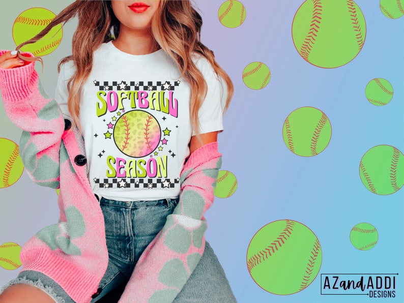 May include: A white t-shirt with a pink and green softball graphic and the text "Softball Season" in a retro style.