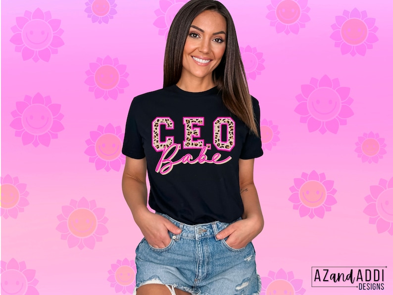May include: Black t-shirt with the text "CEO Babe" in pink letters with a leopard print design. The letters have a white outline.