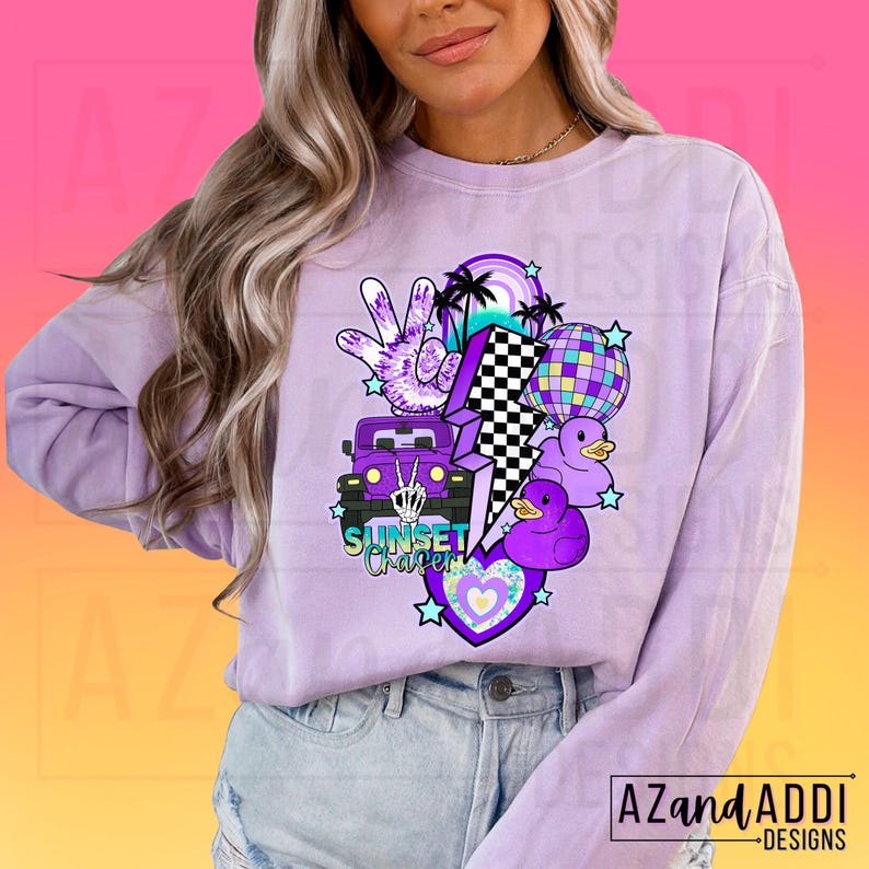 May include: Purple long-sleeved shirt with a graphic design featuring a cartoon jeep, a peace sign, a lightning bolt, a disco ball, and rubber ducks. The text "Sunset Chaser" is printed on the shirt.