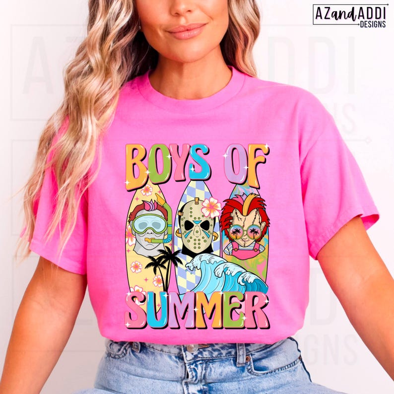 May include: A bright pink t-shirt featuring the words "BOYS OF SUMMER" in a retro font. The graphic includes three surfboards with cartoon characters, a wave, and palm trees. The shirt is a vibrant and eye-catching design.