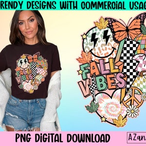 May include: A brown t-shirt with a colourful graphic design featuring a butterfly, lightning bolts, and the text "FALL VIBES". The design includes a peace sign, a checkered pattern, and autumn leaves. The image also includes the text "PNG DIGITAL DOWNLOAD".