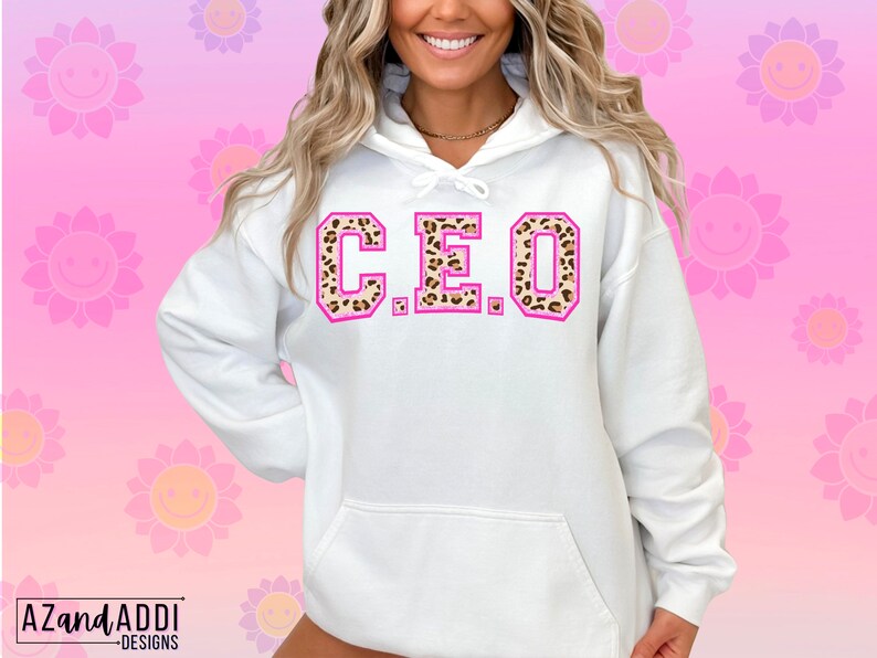 May include: White hooded sweatshirt with a pink outline and leopard print letters spelling "C.E.O."